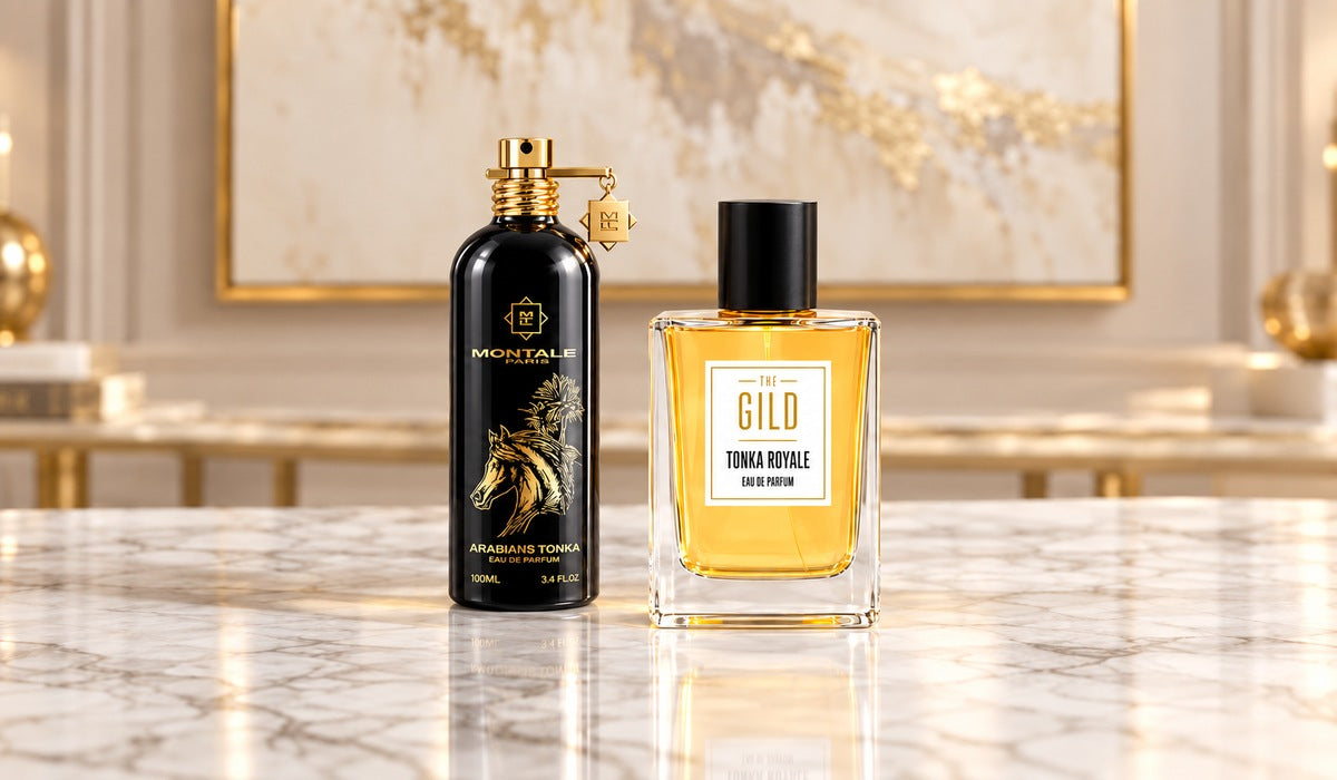 Montale Arabians Tonka and THE GILD Tonka Royale centered on white marble with a blurred creamy painting in a gold frame.