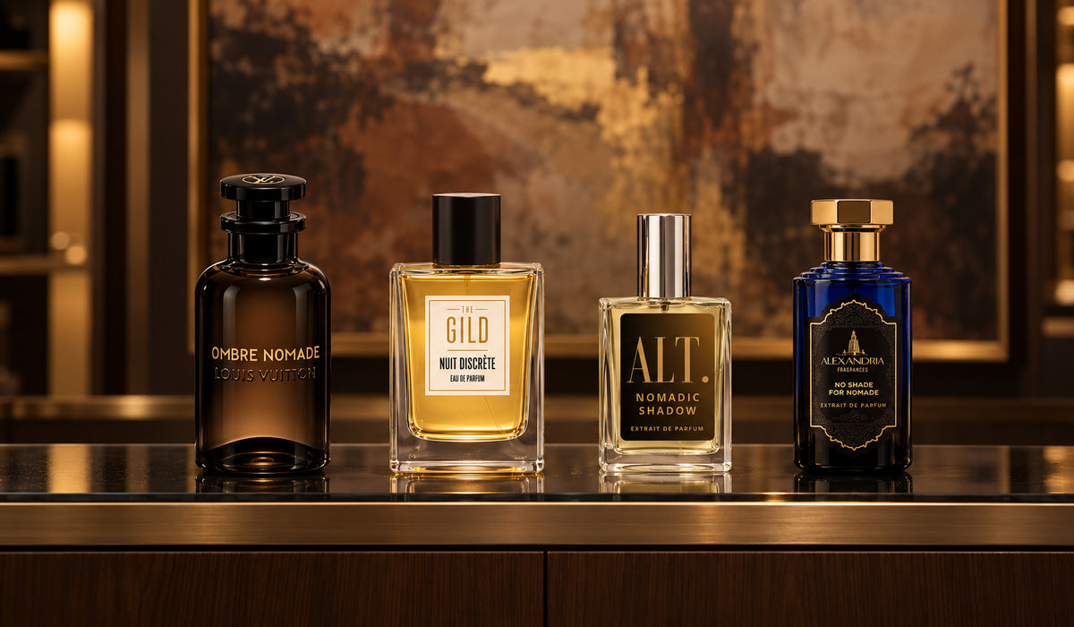 Nuit Discrete, Louis Vuitton Ombre Nomade, ALT. Nomadic Shadow and Alexandria No Shade For Nomade on a luxury glass shelf with a blurred brown painting behind them.