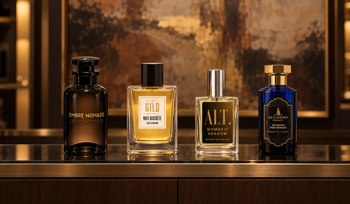 Nuit Discrete, Louis Vuitton Ombre Nomade, ALT. Nomadic Shadow and Alexandria No Shade For Nomade on a luxury glass shelf with a blurred brown painting behind them.